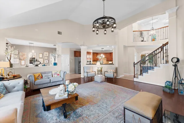 a living room with furniture and a chandelier