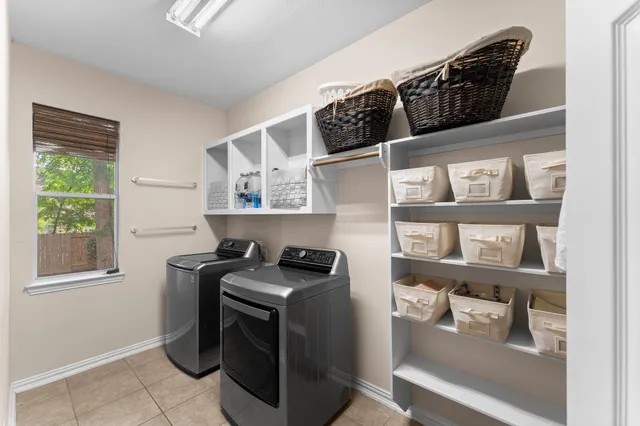 a utility room with cabinets dryer and washer