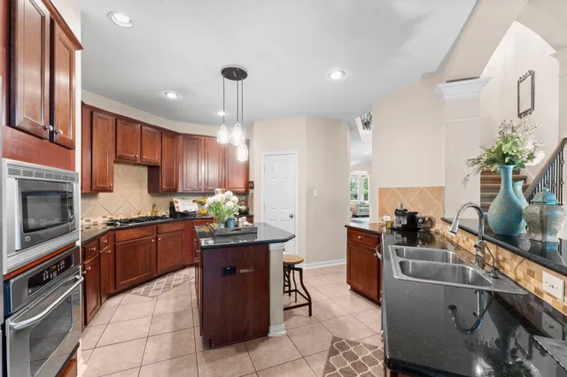 a kitchen with a sink stainless steel appliances and cabinets