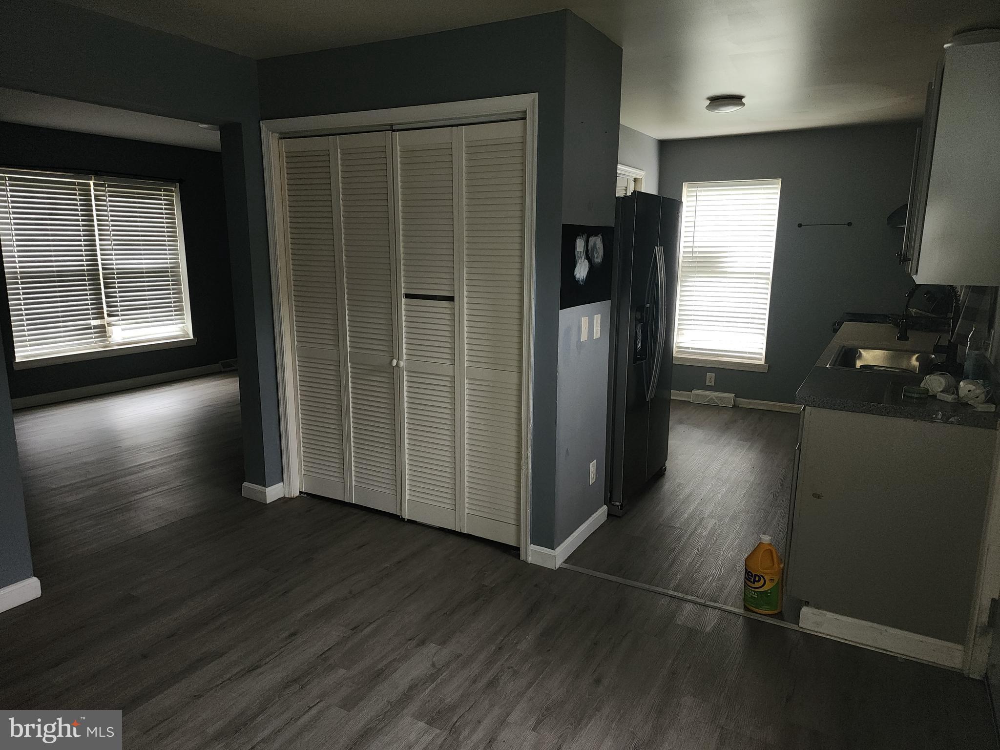 114 Spruance Road Dover, DE 19901 - Photo 3 of 12 an empty room with wooden floor and windows