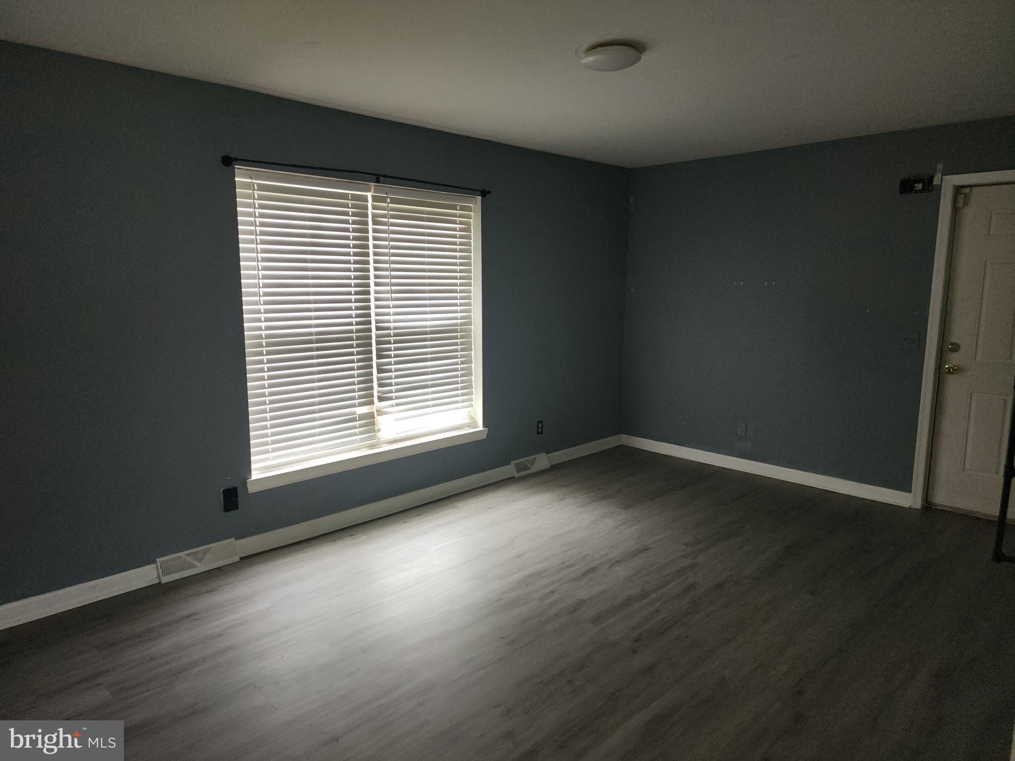 114 Spruance Road Dover, DE 19901 - Photo 7 of 12 a view of wooden floor and windows in a room