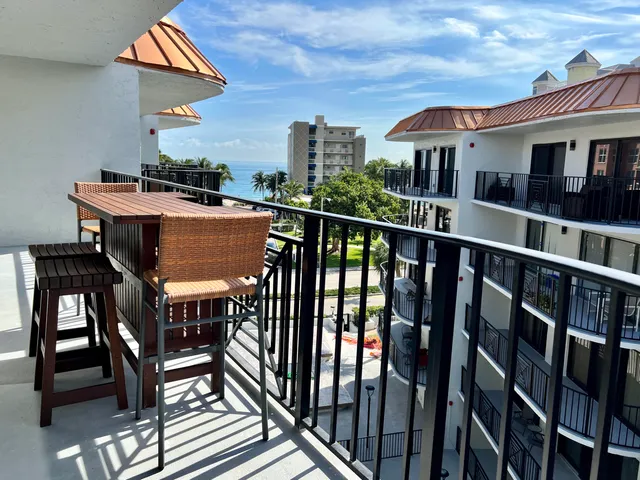 a view of a chairs and table in the balcony