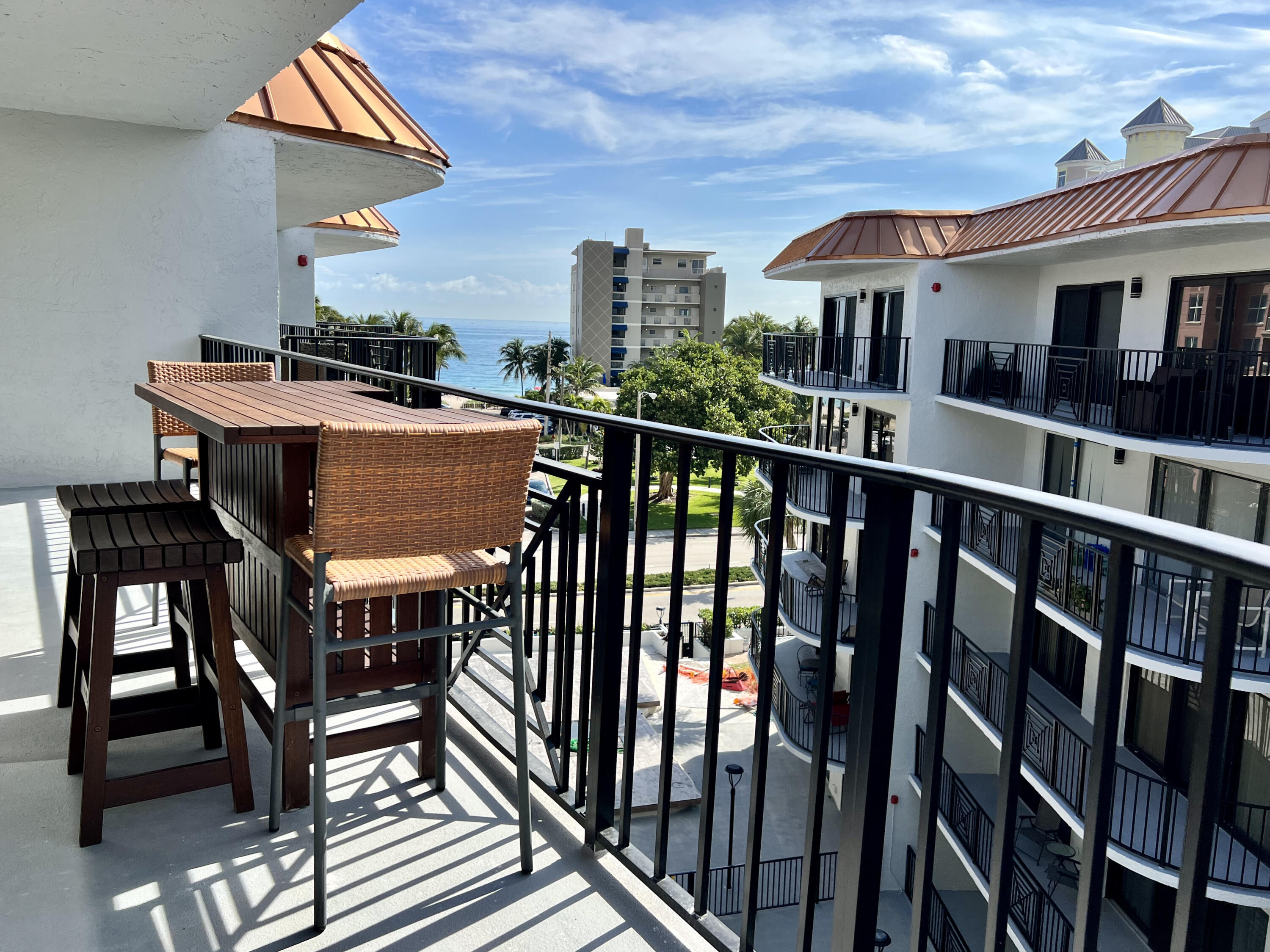 a view of a chairs and table in the balcony