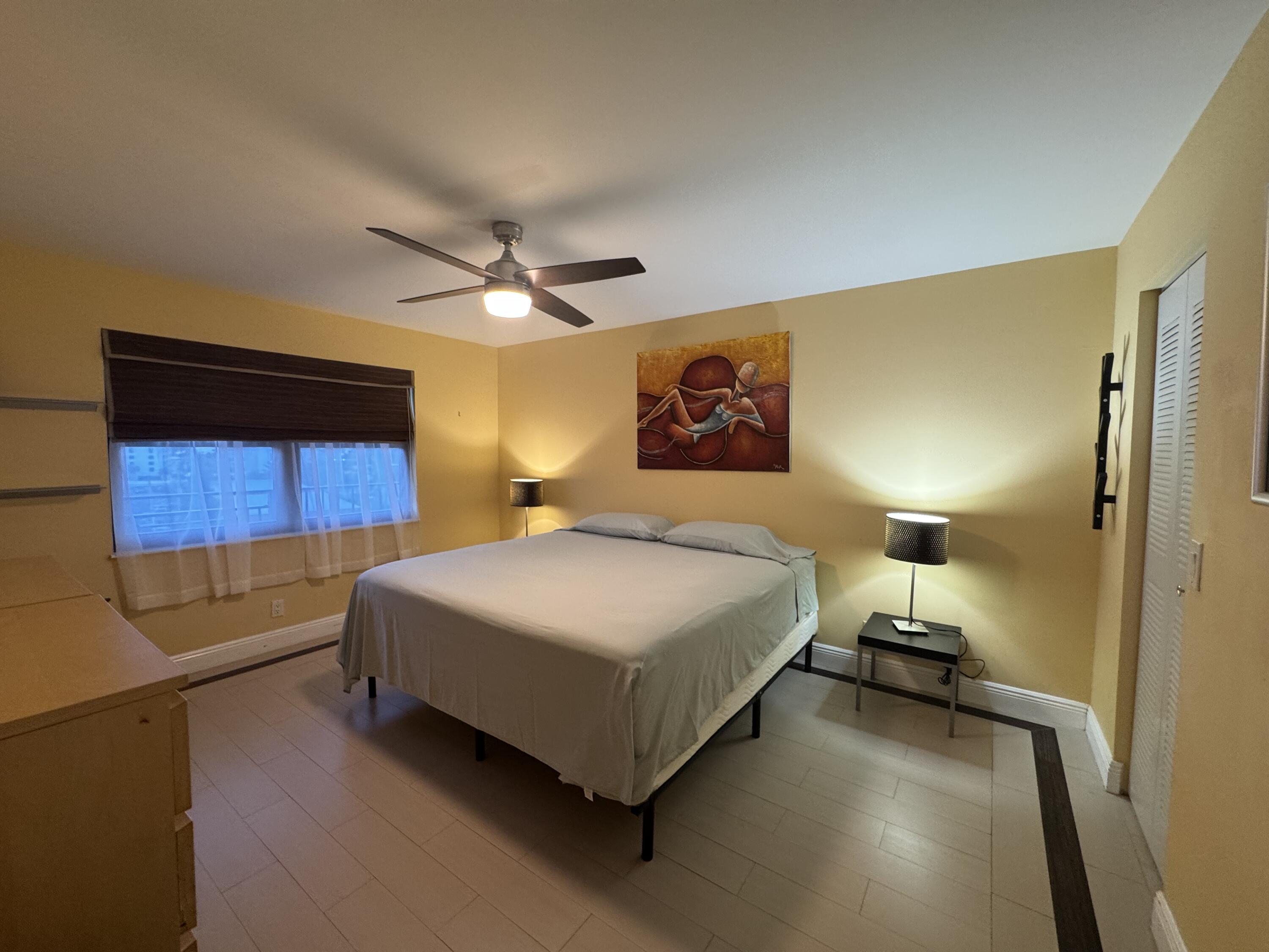 2029 North Ocean Boulevard, Unit 510 Fort Lauderdale, FL 33305 - Photo 15 of 39 a bedroom with a bed and a wall painting