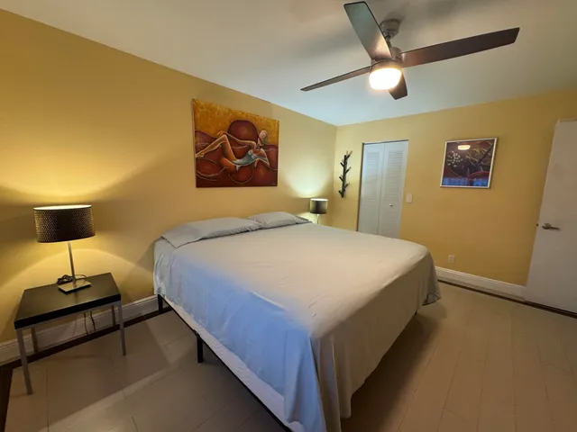 a bedroom with a bed and a wall painting