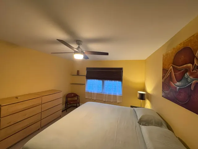 a bedroom with a bed and cabinets