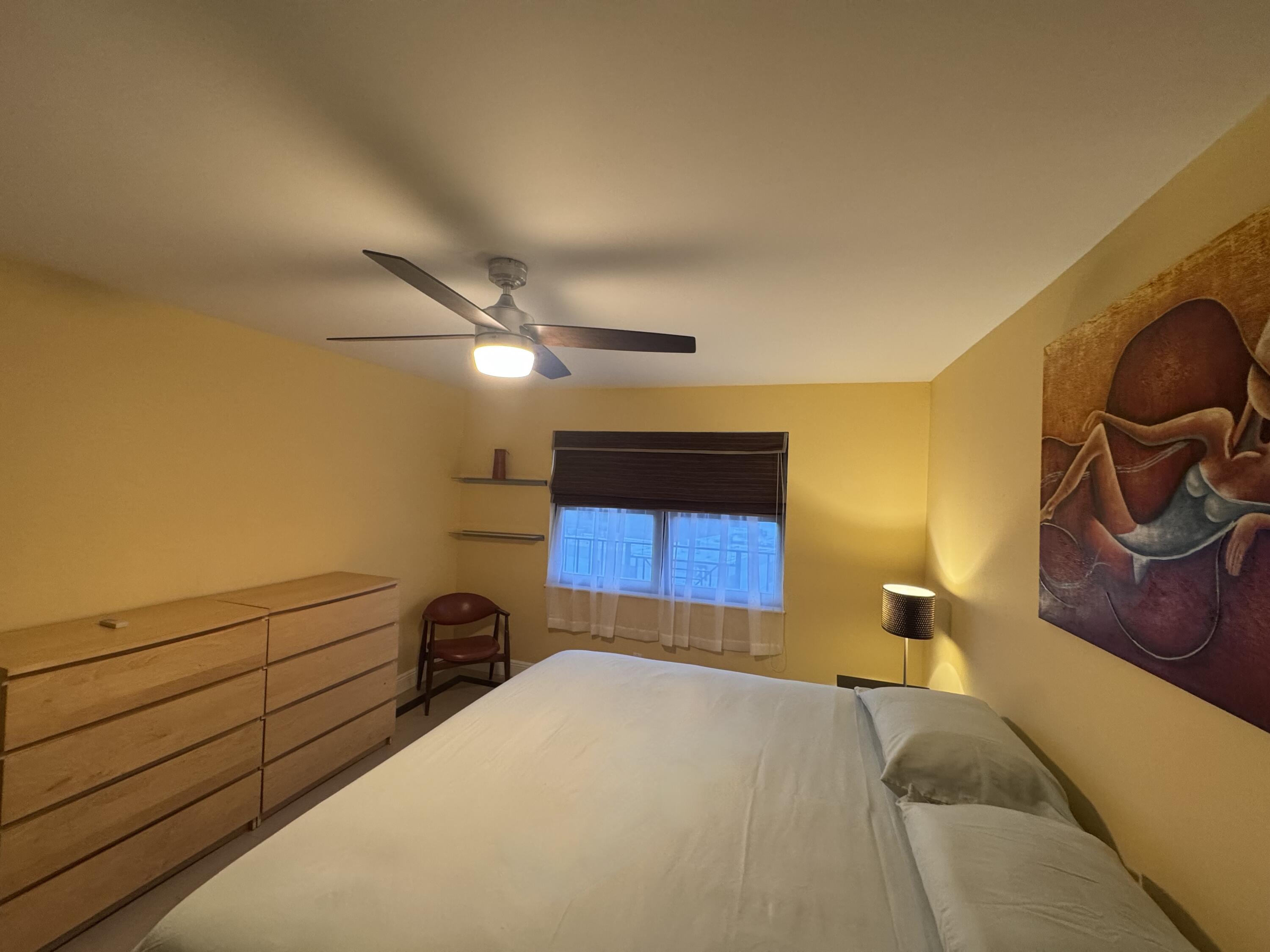 2029 North Ocean Boulevard, Unit 510 Fort Lauderdale, FL 33305 - Photo 17 of 39 a bedroom with a bed and cabinets