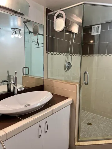 a bathroom with a sink toilet and shower