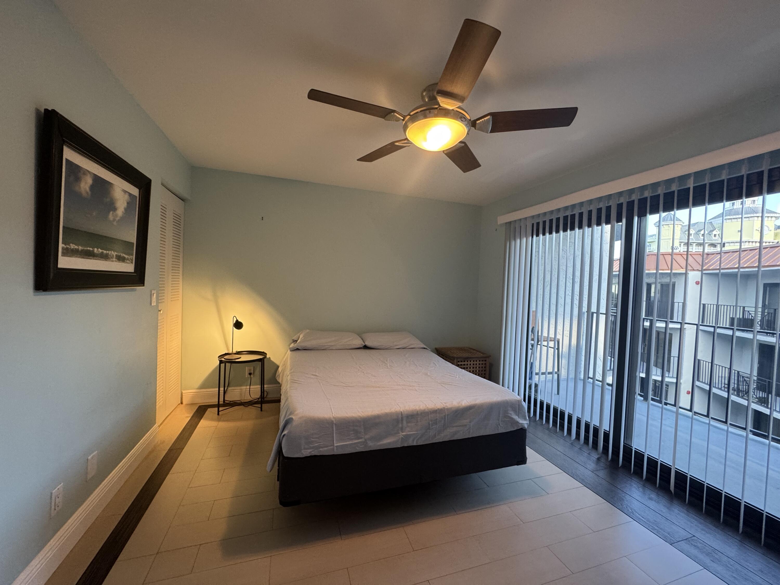 2029 North Ocean Boulevard, Unit 510 Fort Lauderdale, FL 33305 - Photo 20 of 39 a bedroom with a bed and a chandelier