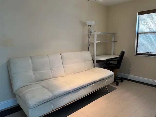 a bedroom with a bed and window