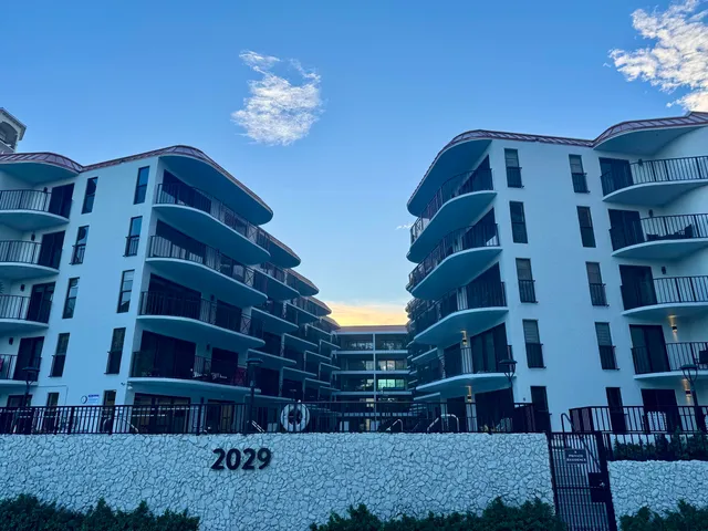 a view of a swimming pool with outdoor seating and plants