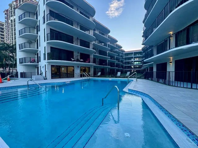 a view of a roof deck with wooden floor and outdoor seating