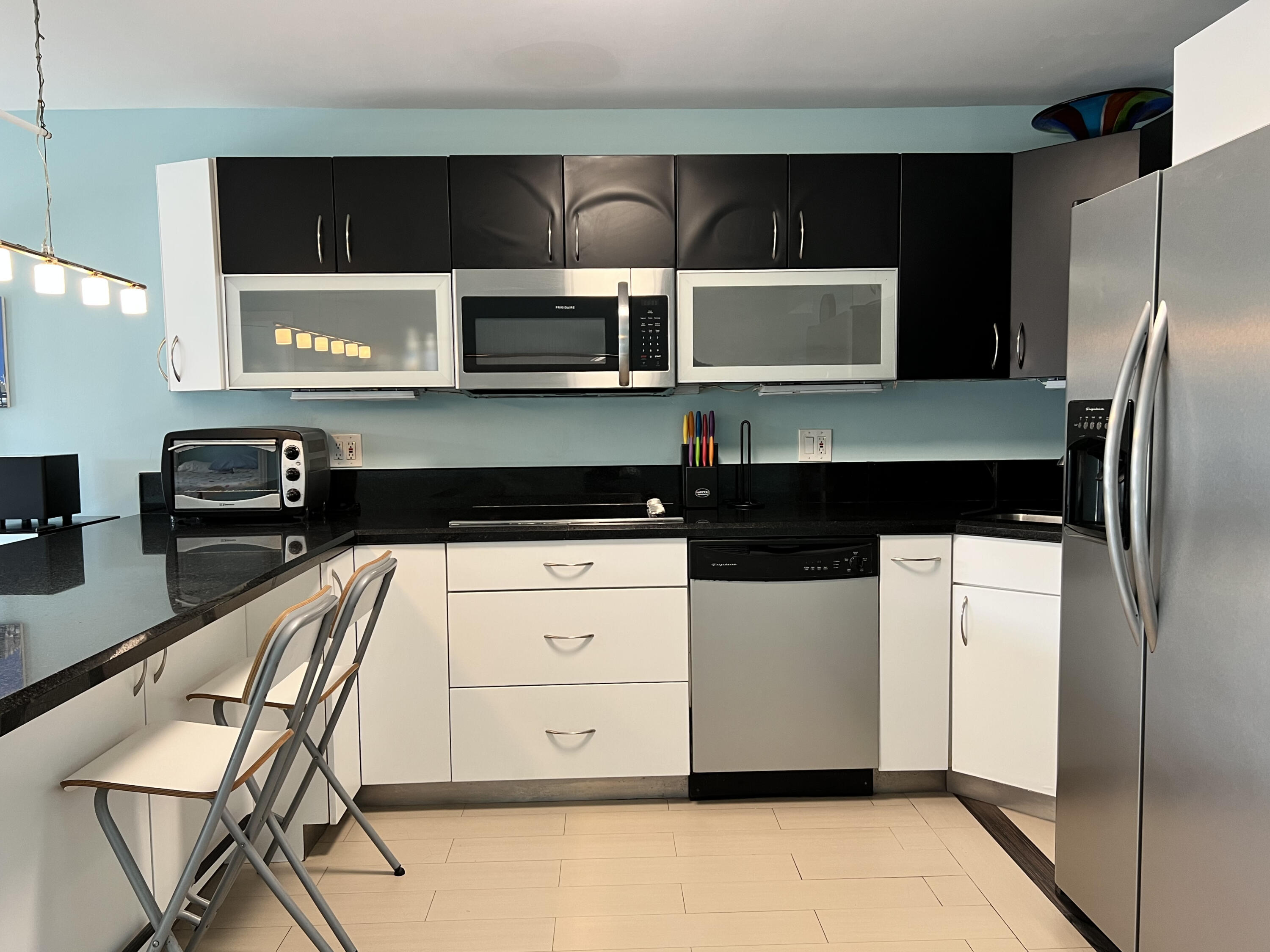 2029 North Ocean Boulevard, Unit 510 Fort Lauderdale, FL 33305 - Photo 8 of 39 a kitchen with a refrigerator and a stove top oven