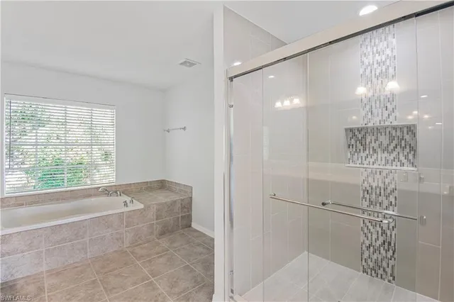 a bathroom with a bathtub and shower