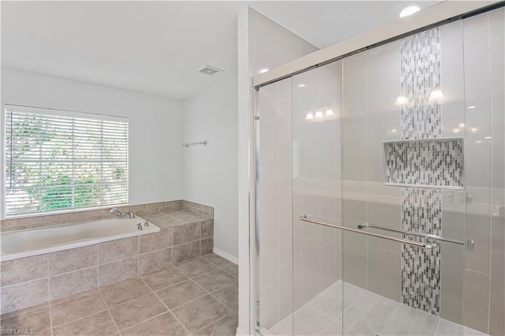 2133 Fairmont Lane Naples, FL 34120 - Photo 12 of 31 a bathroom with a bathtub and shower
