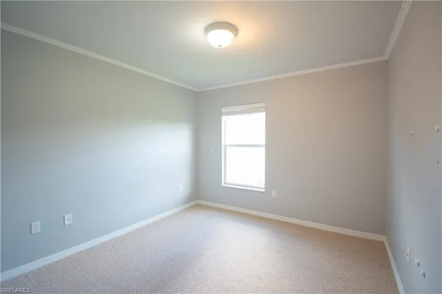 an empty room with a window and wooden floor