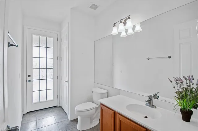 a bathroom with a toilet a sink and mirror