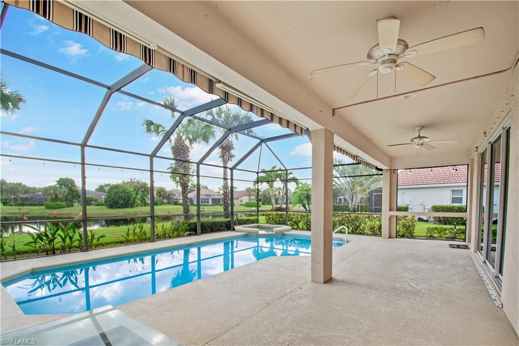 2133 Fairmont Lane Naples, FL 34120 - Photo 20 of 31 a view of a room with a large window and wooden floor