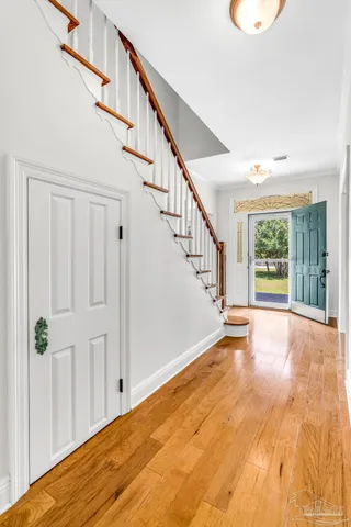 a kitchen with stainless steel appliances granite countertop a stove a sink dishwasher and a refrigerator with wooden floor