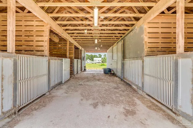 a view of a room with wooden floor and electronic appliances
