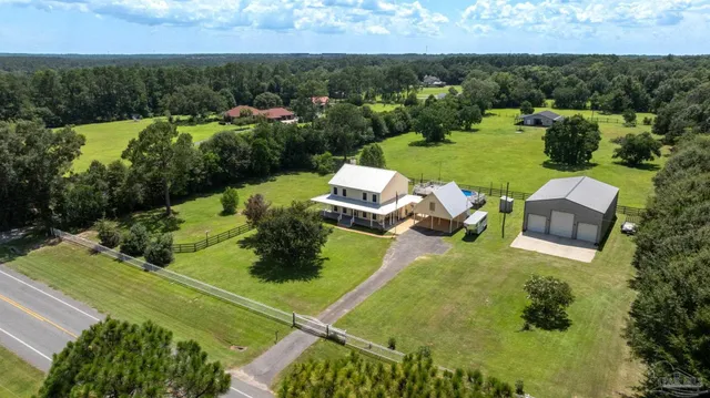 an aerial view of a house with a yard