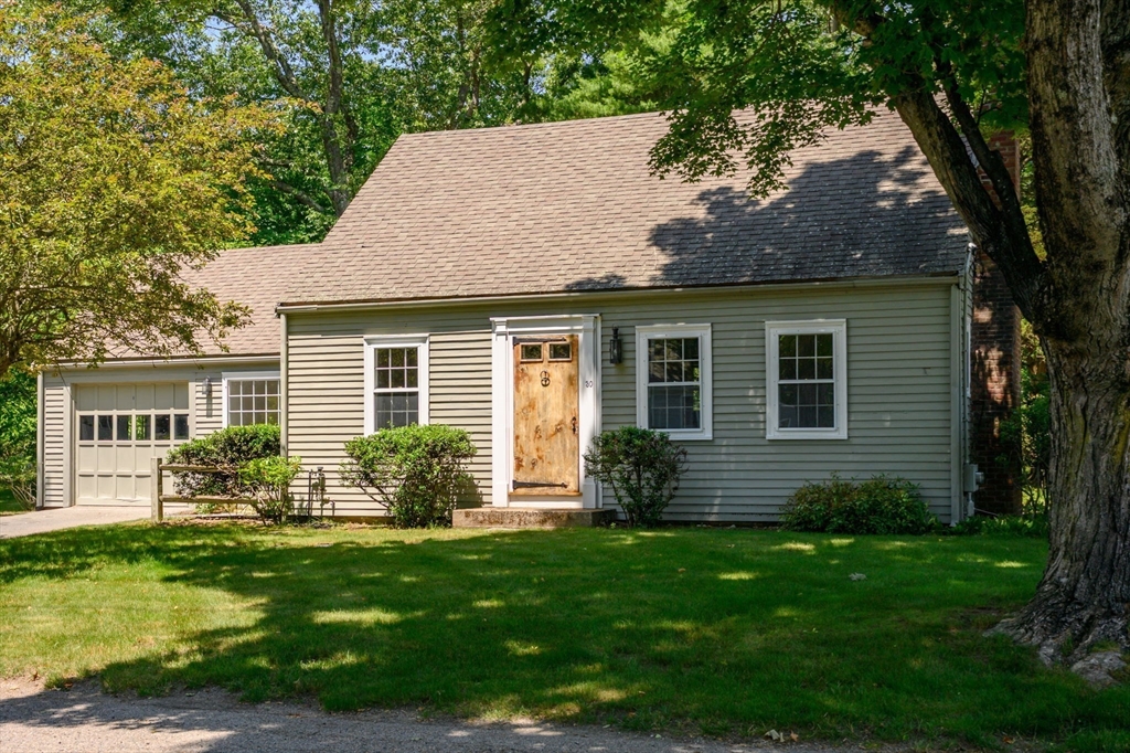 a front view of house with yard and green space