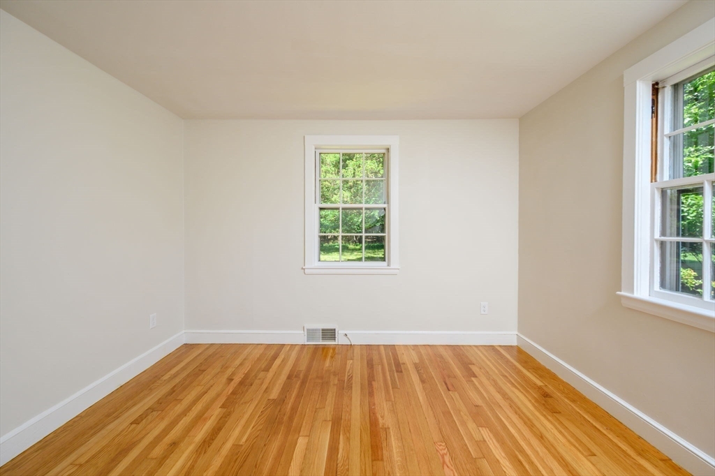 30 Huntley Road Hingham, MA 02043 - Photo 15 of 28 an empty room with a window and wooden floor
