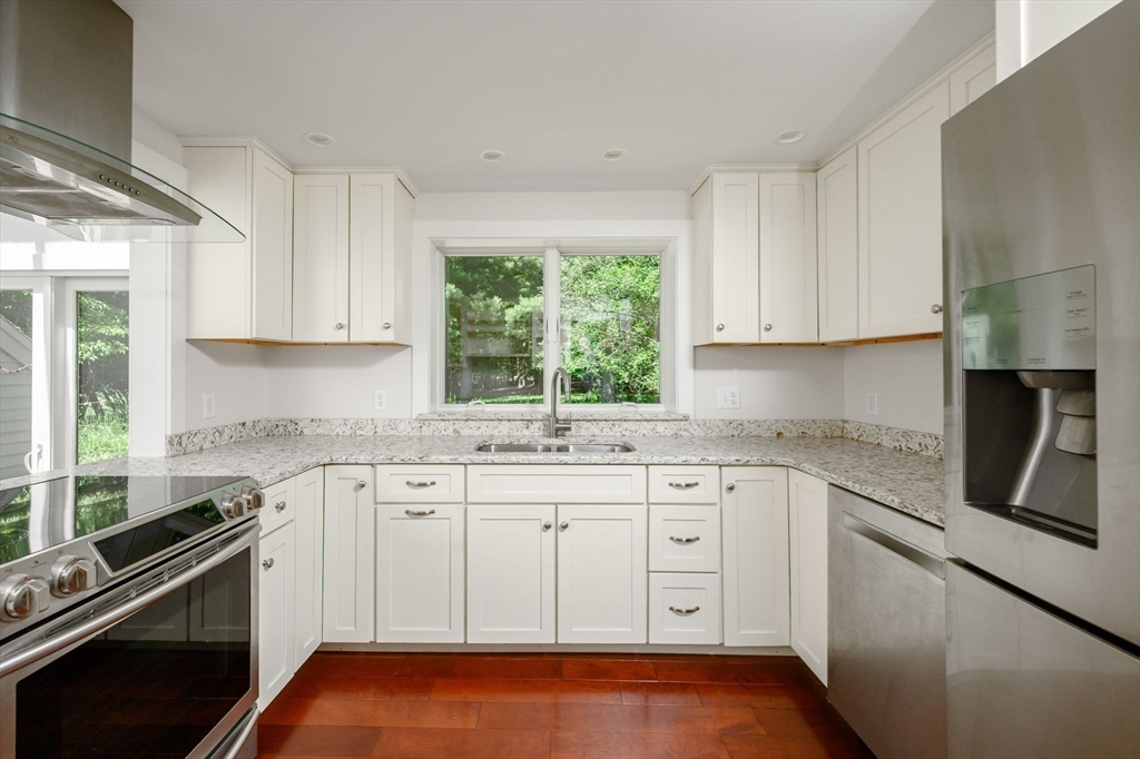 30 Huntley Road Hingham, MA 02043 - Photo 7 of 28 a kitchen with granite countertop white cabinets and appliances