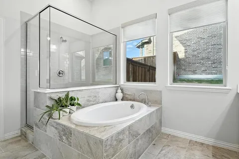 a bathroom with a tub shower and sink
