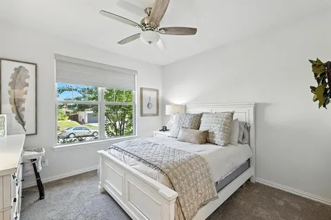 a bedroom with a large bed and a large window