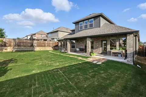 a front view of a house with a yard table and chairs