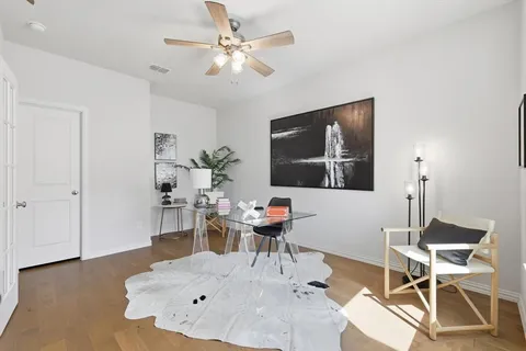 a living room with furniture and a wooden floor