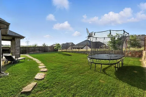 a view of a bench in the garden near a lake