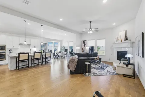 a living room with fireplace furniture and a chandelier