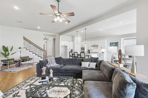 a living room with furniture a fireplace and a chandelier