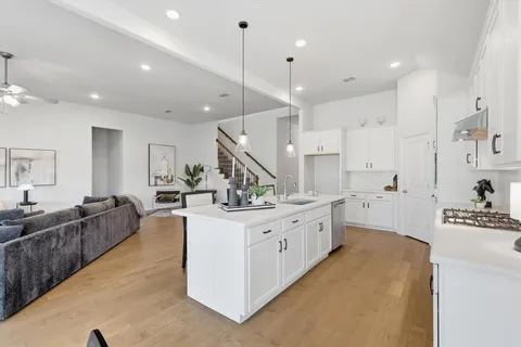 a large white kitchen with lots of counter space