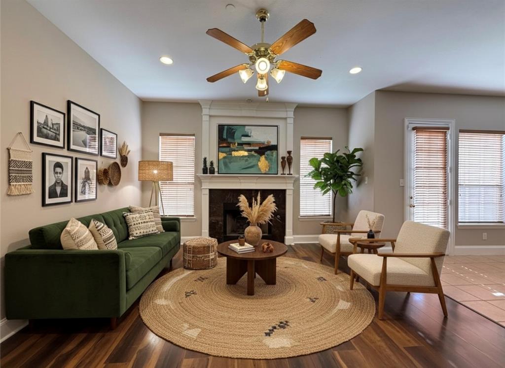 a living room with furniture a fireplace and a large window