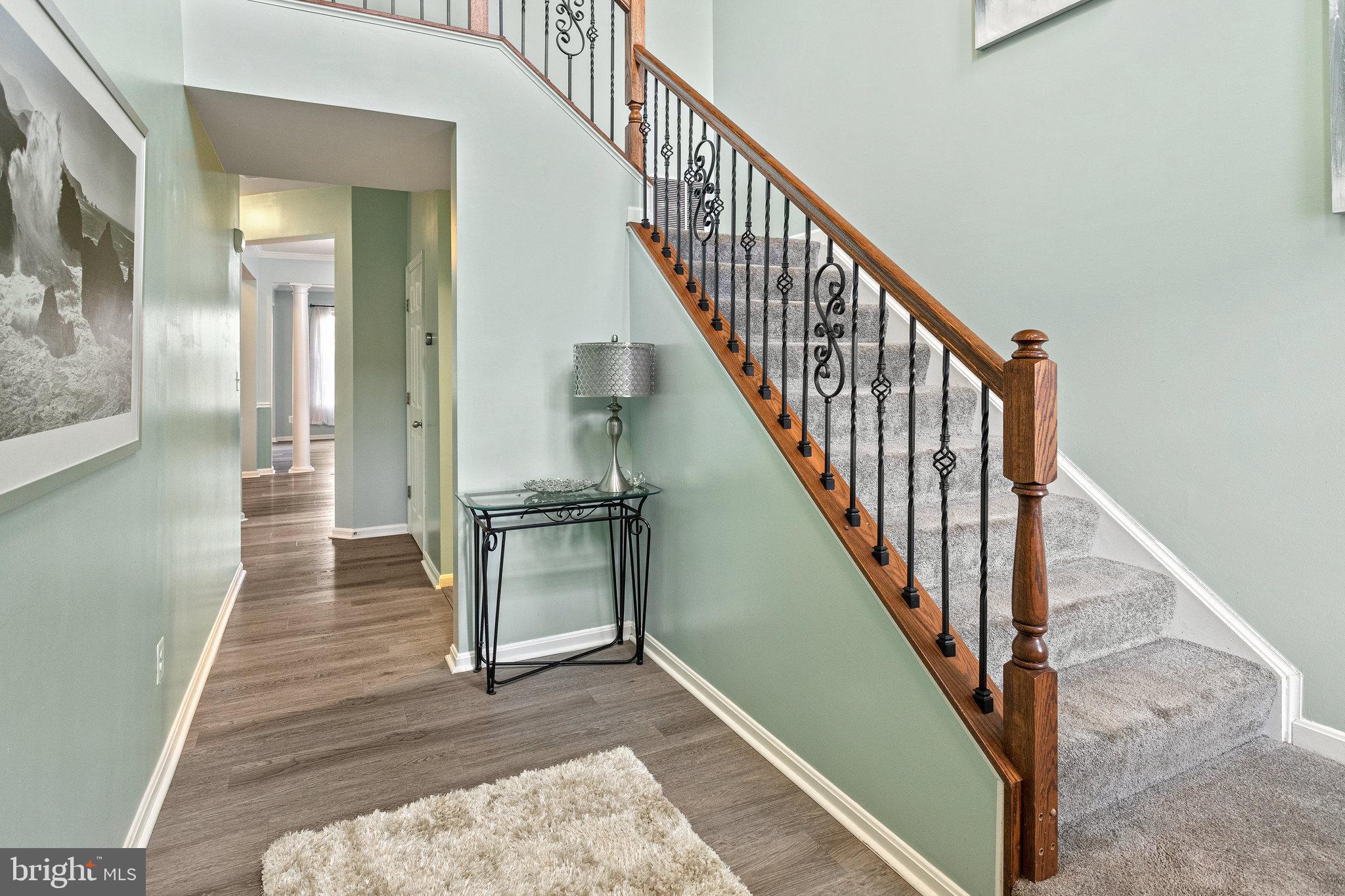 3445 Eagle Ridge Drive Woodbridge, VA 22191 - Photo 4 of 39 a view of a hallway with wooden floor and staircase