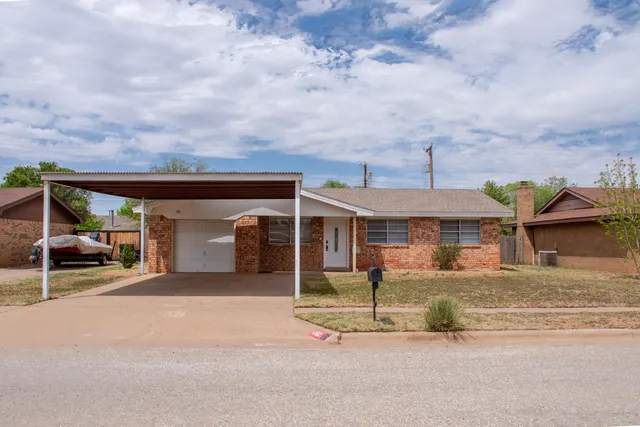 an outdoor view of house and garage