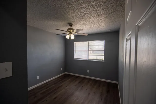 a view of a backyard with table and chairs with wooden fence