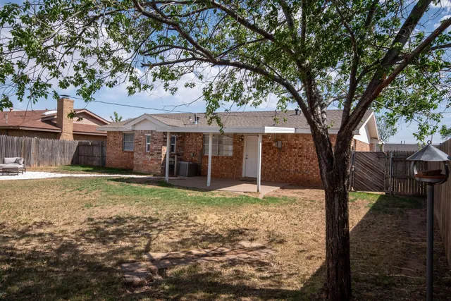 a view of a backyard with table and chairs