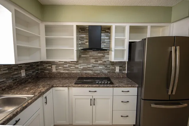a kitchen with a refrigerator and a sink