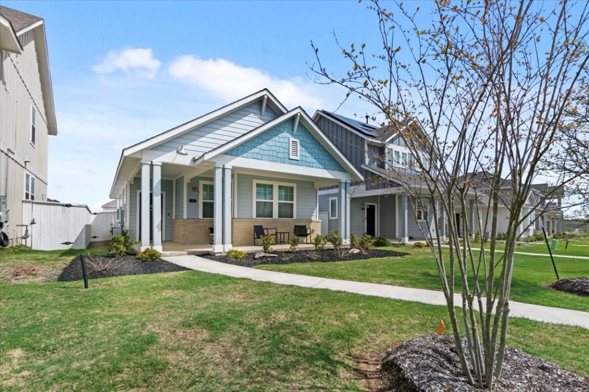 148 Harvest Rdg Boulevard Elgin, TX 78621 - Photo 1 of 1 a front view of a house with sitting space and garden
