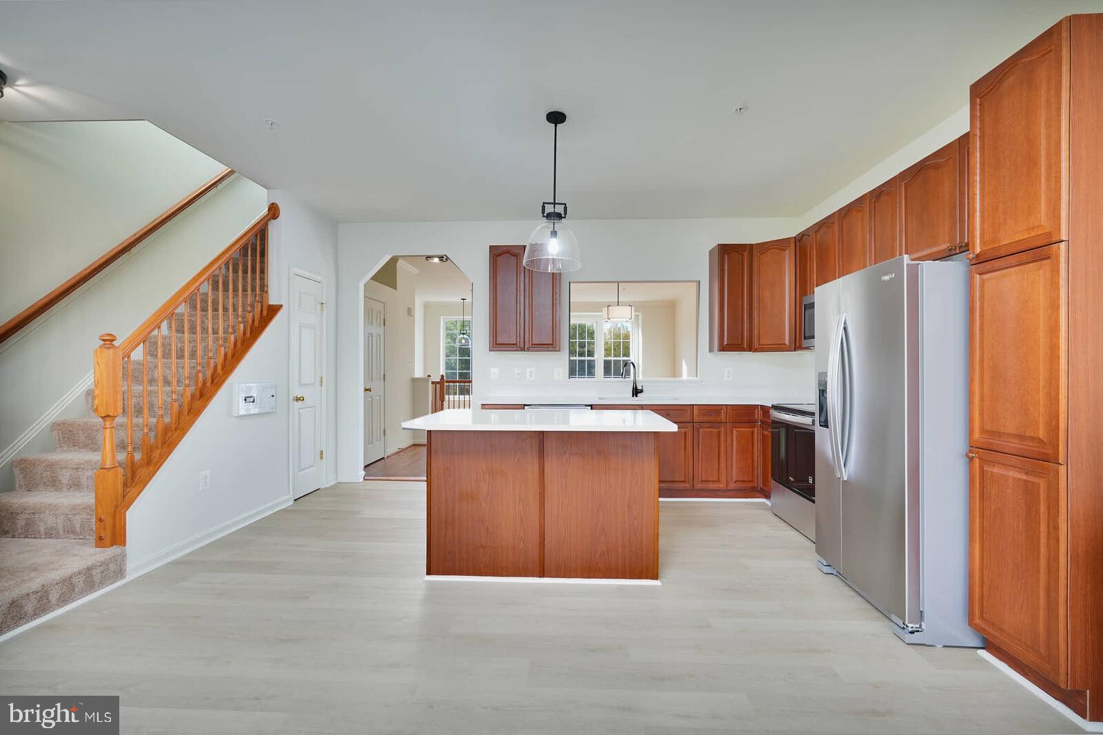 3506 Connor Place Frederick, MD 21704 - Photo 1 of 34 a large kitchen with kitchen island granite countertop a refrigerator a sink dishwasher a oven with a dining table and chairs