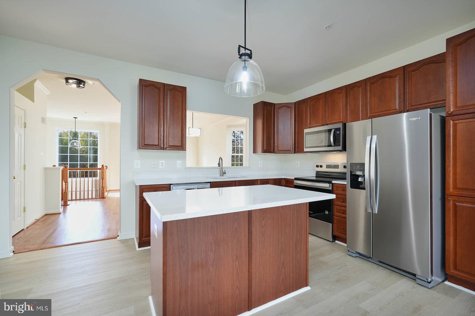 3506 Connor Place Frederick, MD 21704 - Photo 11 of 34 a kitchen with stainless steel appliances granite countertop a refrigerator a sink dishwasher a stove oven and a sink with wooden floor