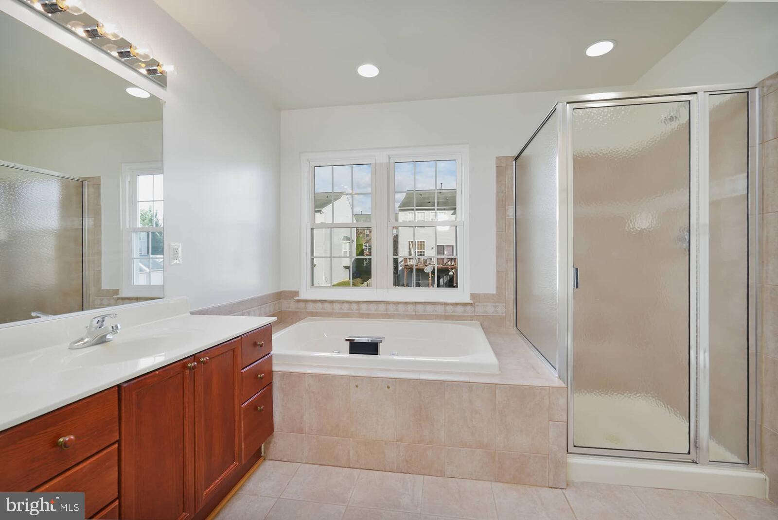 3506 Connor Place Frederick, MD 21704 - Photo 17 of 34 a bathroom with a tub sink and mirror