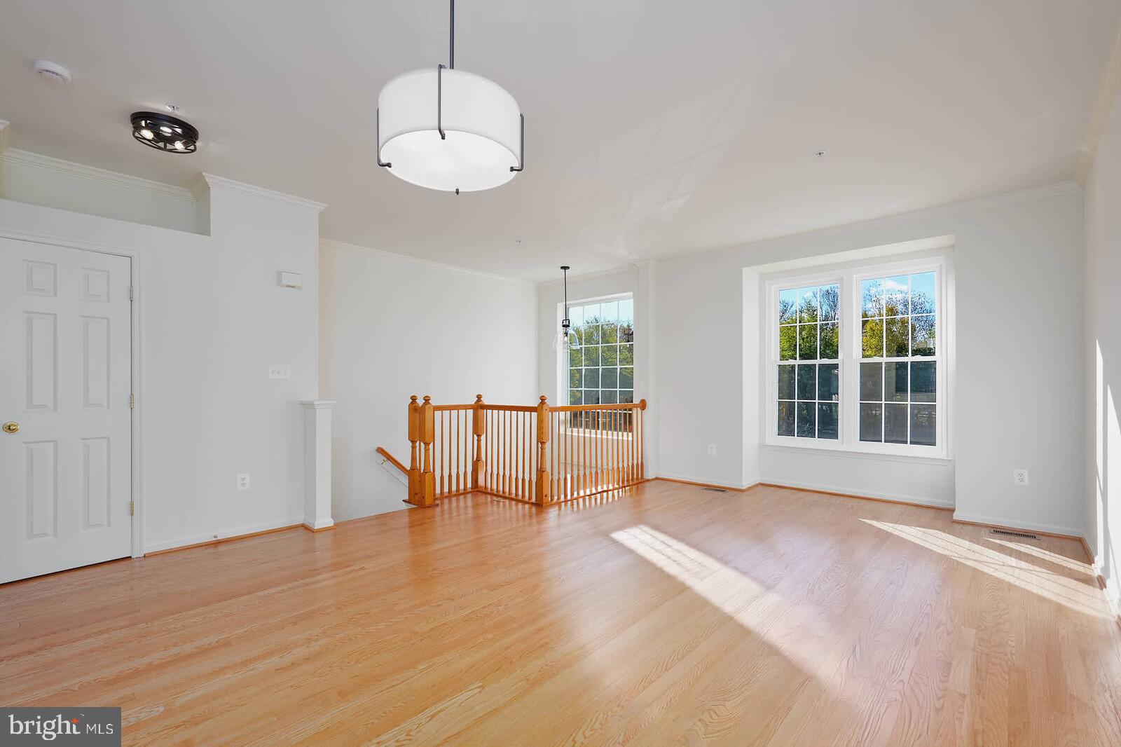 3506 Connor Place Frederick, MD 21704 - Photo 5 of 34 a view of an empty room with a window and wooden floor