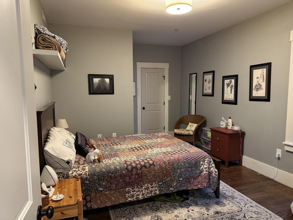 19 Macarthur Street, Unit 2 Somerville, MA 02145 - Photo 5 of 18 a bedroom with a bed and wooden floor