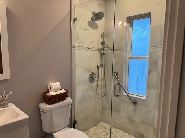 a bathroom with a toilet and a shower