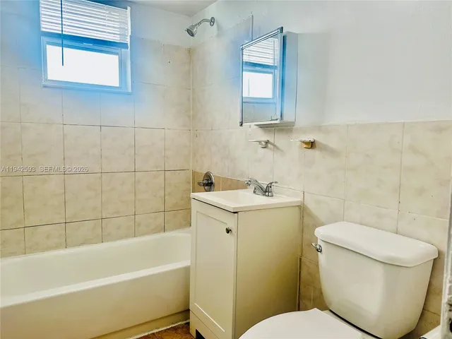 a bathroom with a sink toilet and bathtub